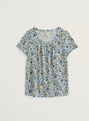 Floral patterned top on a light grey background.