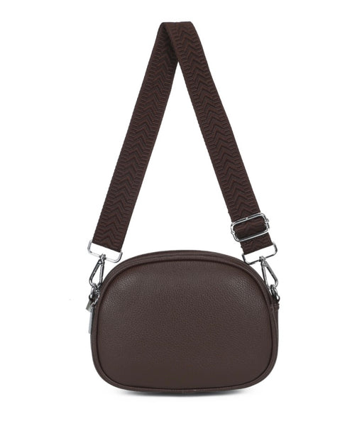 A crossbody coffee handbag with adjustable pattern strap. With zipper fastening displayed on a white background.