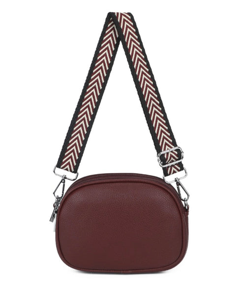 Crossbody bag small in wine with pattern strap and adjustable and detachable strap. With zipper closure display on a white background.
