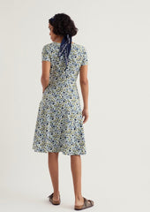 Woman wearing a floral dress on a plain background