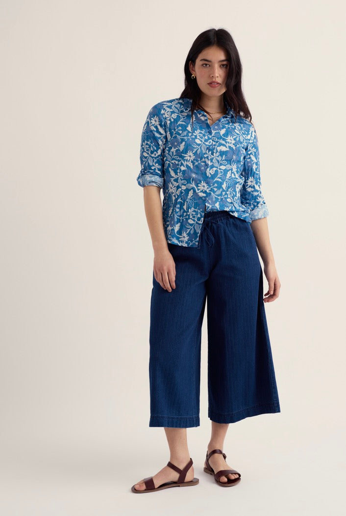 Seasalt blue floral blouse styled with dark blue wide-leg trousers.