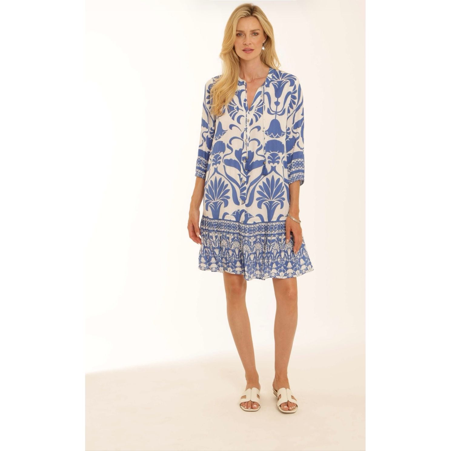 Model wearing Pomodoro blue and white abstract print dress with white sandals 