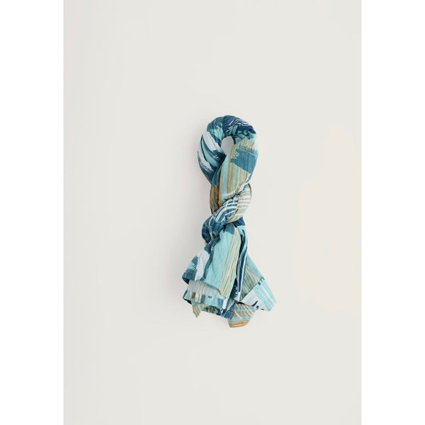 Blue patterned scarf on a light grey background.