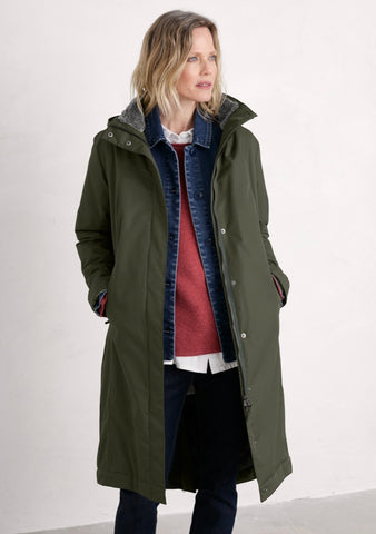 Seasalt olive green hooded  jacket with a high collar, front zipper, and zippered side pockets, shown against a plain light grey background.
