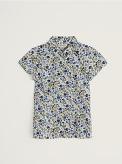 Floral patterned shirt on a light grey background.