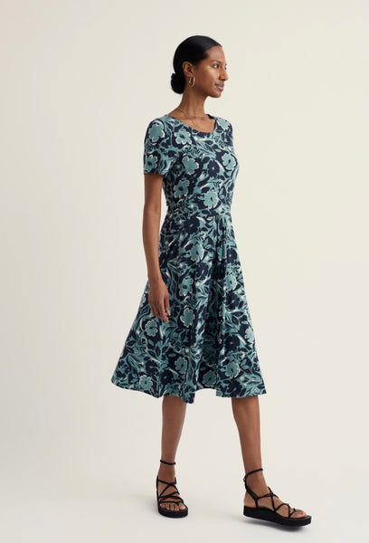 Woman wearing a floral dress on a plain background