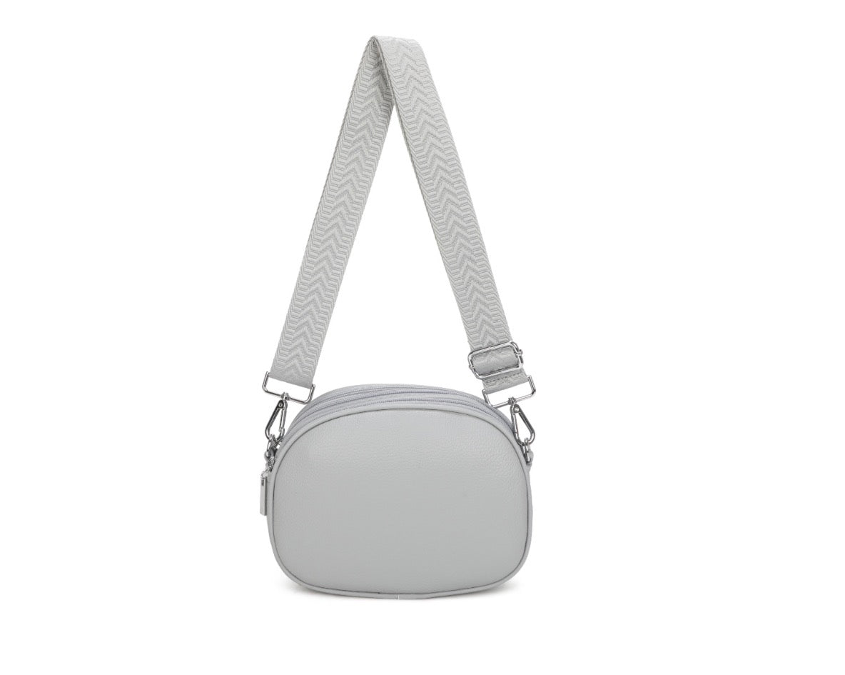 Gray crossbody bag with a strap on a white background