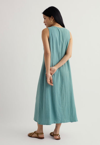Woman wearing a light blue dress on a white background.