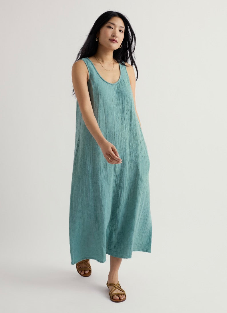 Woman wearing a light blue dress on a white background.