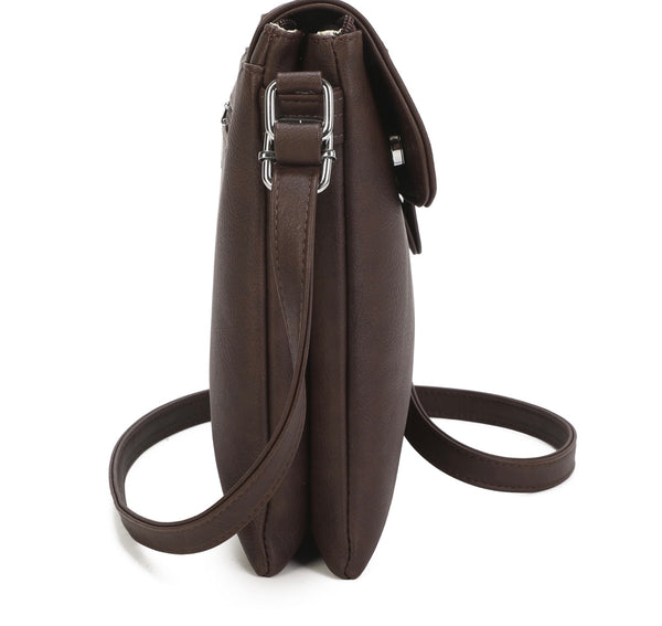 Side profile of brown handbag with strap on white background 