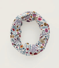 Seasalt fabric headband with a dense, multicolour floral and botanical print on a white background, photographed against a clean off white studio backdrop.