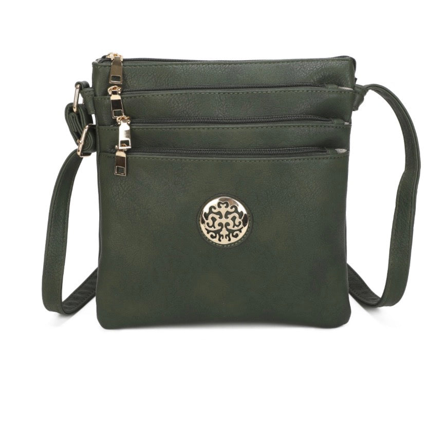 Dark green Crossbody Handbag with compartments with zipper fastening. Adjustable shoulder strap. Gold tree of life motif. Display against a white background.