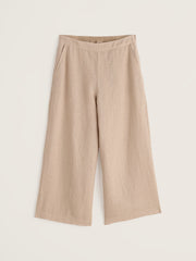 Beige wide-leg pants on a light beige background.