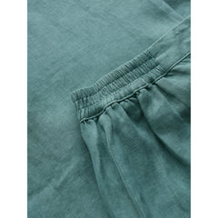 Close-up of teal fabric with an elastic waistband.